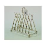 A silver plated toast rack, in the form of crossed rifles,
