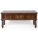 A 17th/18th century oak dresser base, having three frieze drawers with geometric moulded fronts,