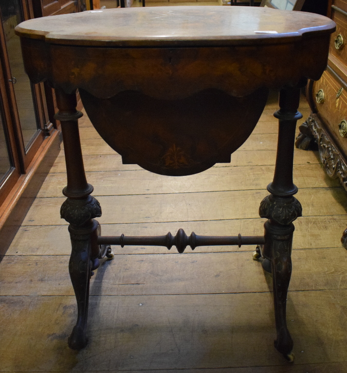 A Victorian inlaid burr walnut work table, of shaped oval form,