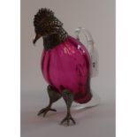 A novelty cranberry glass decanter, with plated mounts, in the form of a parrot,