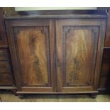 A 19th century mahogany linen press, having a pair of panel doors, on bun feet,