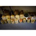 Assorted stoneware flagons, glass bottles and similar items,