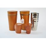 A set of eight travelling beakers, in two leather cases,