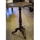 An octagonal tripod table, the top with a geometric parquetry inlay top, and a brass gallery,