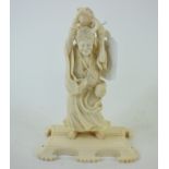 A Japanese carved ivory figure, holding a toad aloft, on a plinth base, 14.