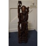 A carved hardwood Chinese Shou Lou figur