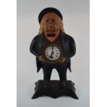 A figural painted metal clock, in the fo