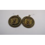 A pair of brass roundels, applied busts,