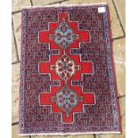 A Persian rug, with a triple medallion o