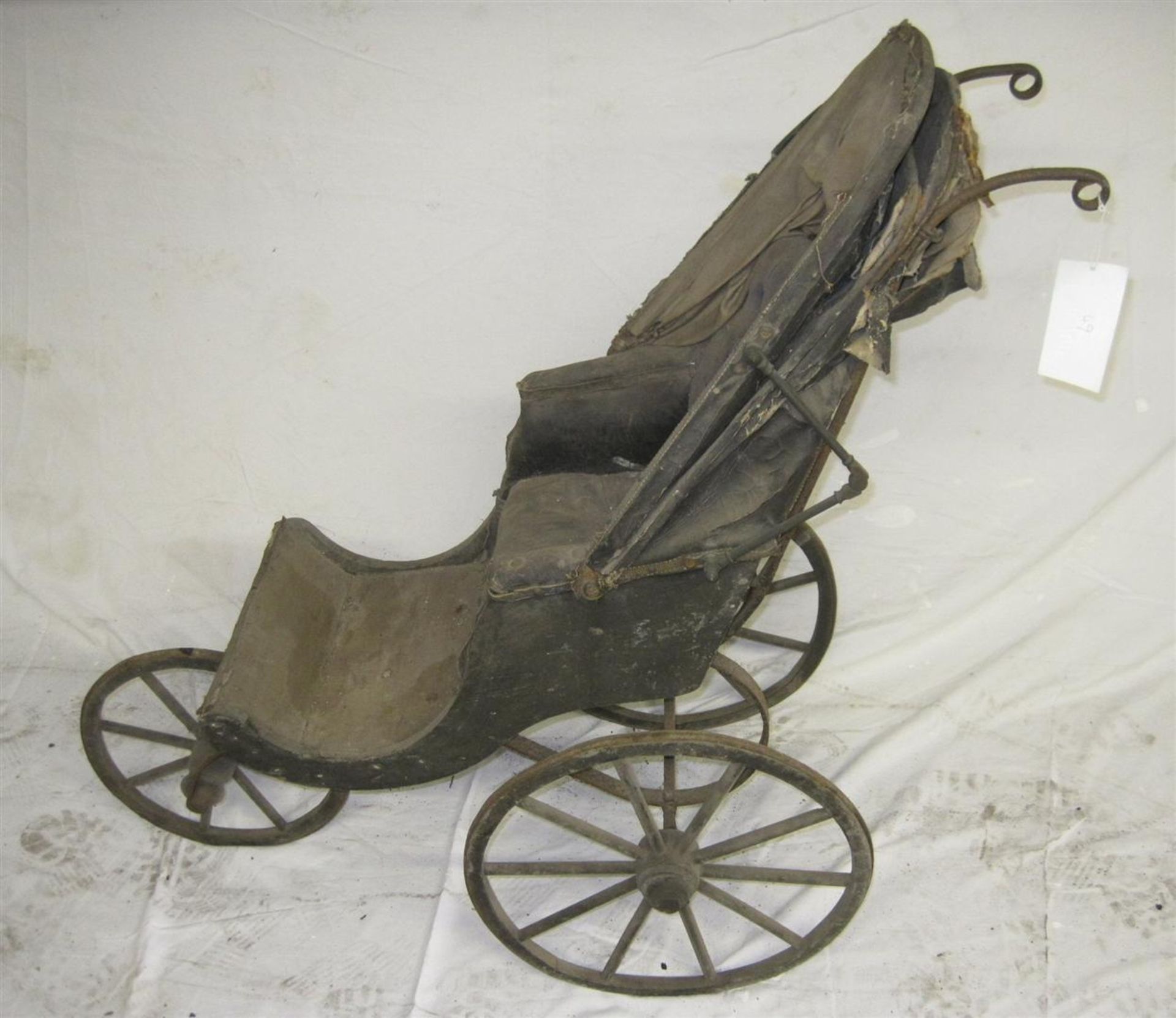 19th century child's push chair of wood and iron construction for restoration
