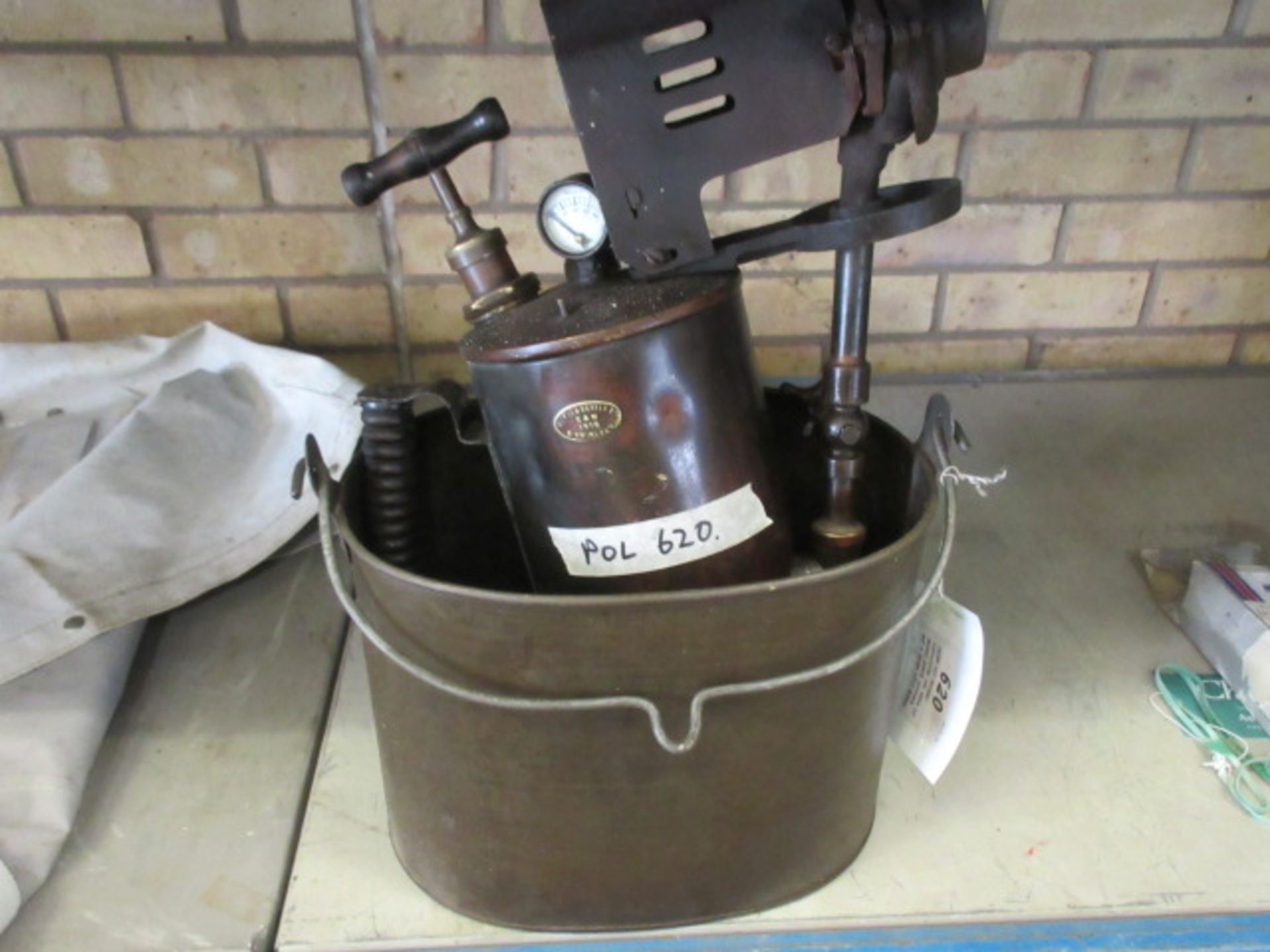 Large oil bucket containing two sets of Gasket punch cutters and a large 1918 Howes and Burlly Ltd