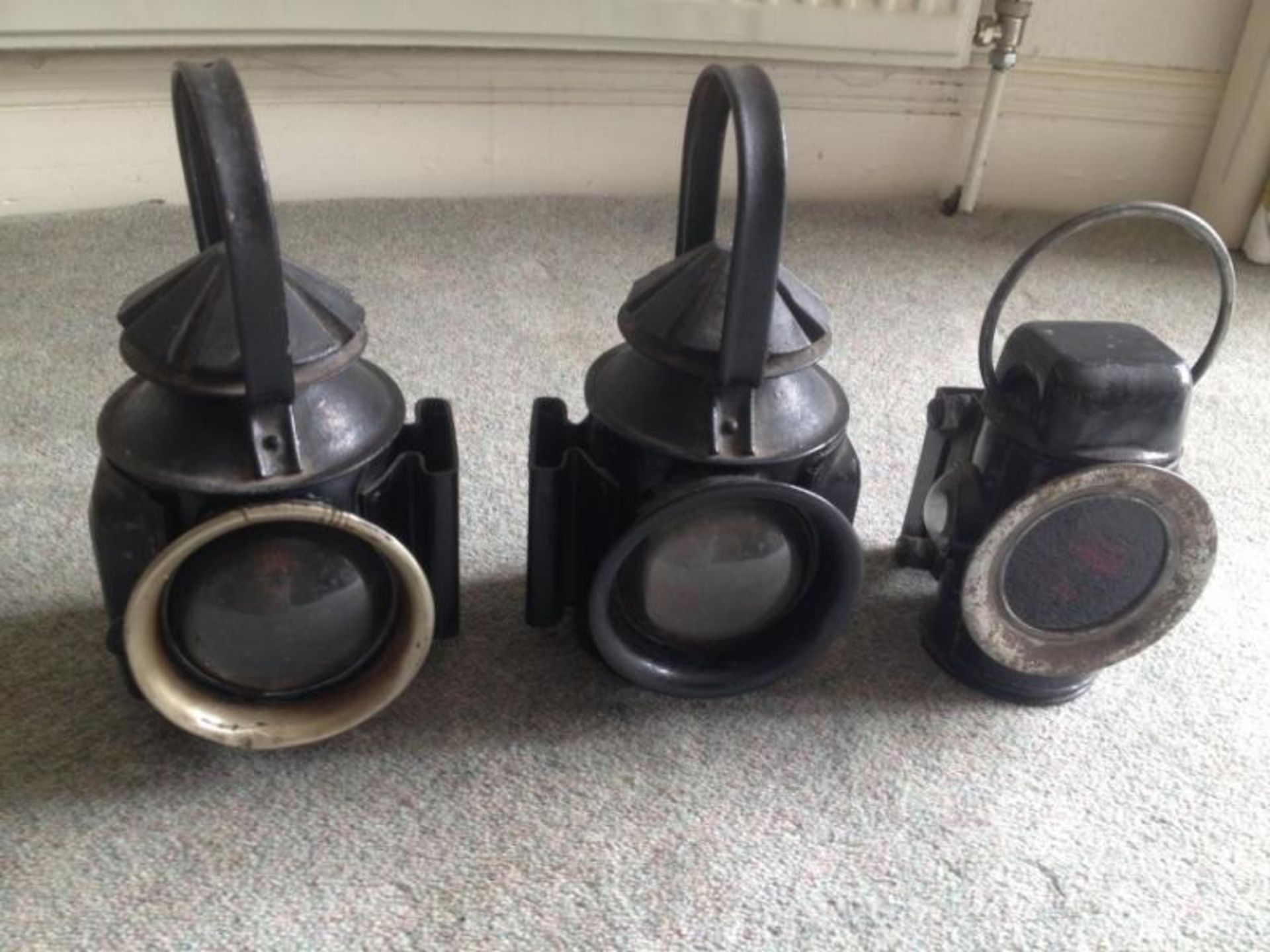 Set of black Eli Griffiths & Sons lamps, pair of spade mounted front and sprung mounted rear