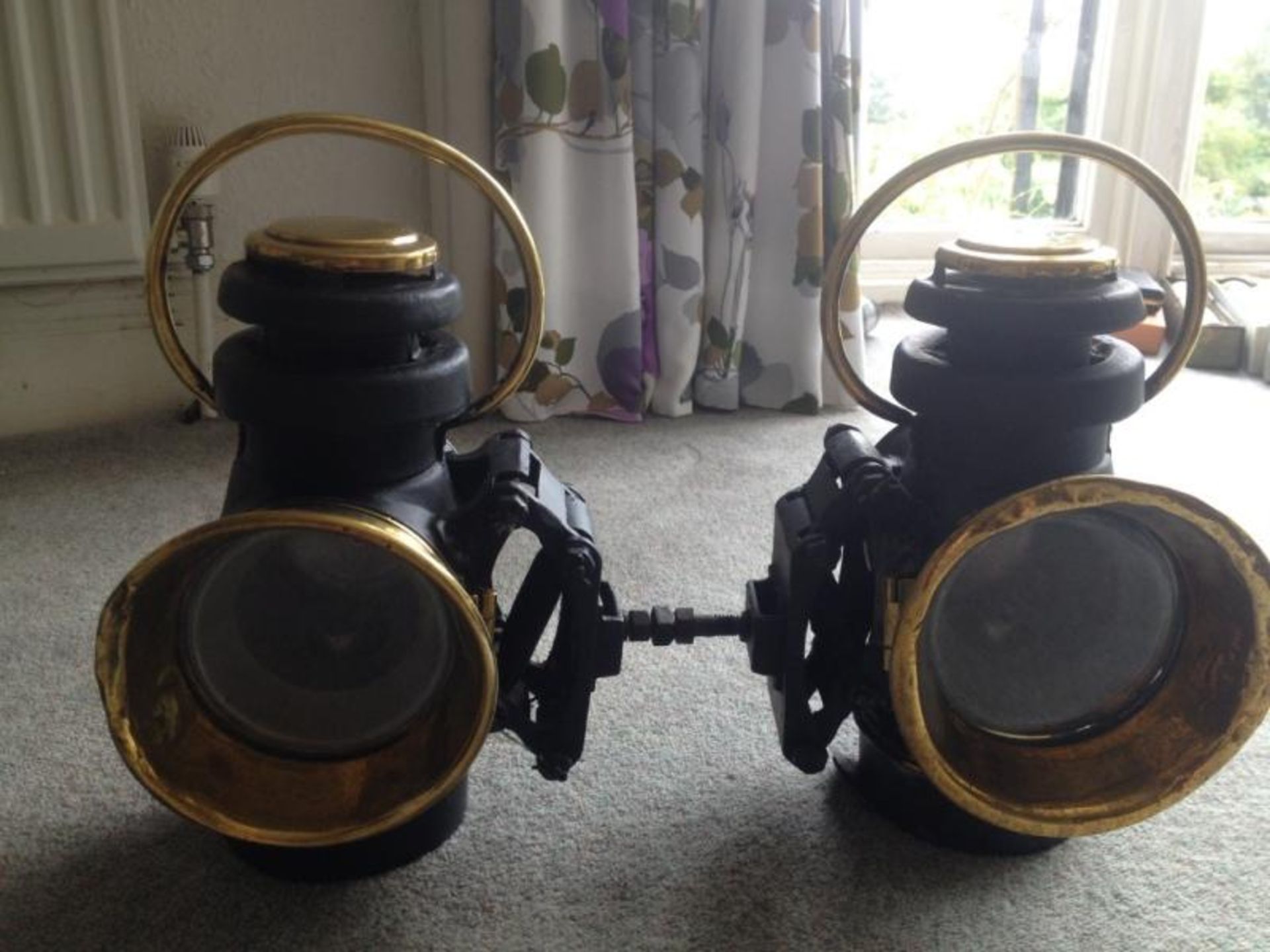 Pair of Eli Griffiths & Sons sprung mounted brass lamps, handed