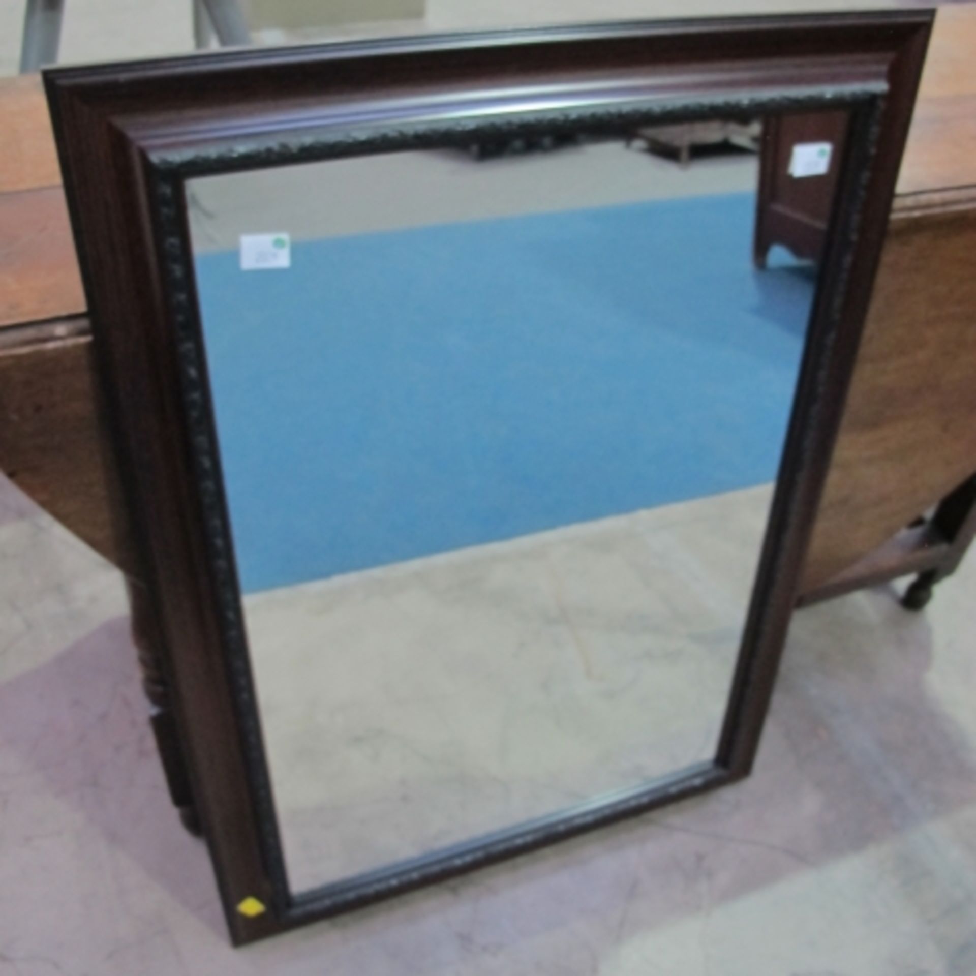 A dark wooden framed plain mirror, 63cm x 89cm (est £20-£40)