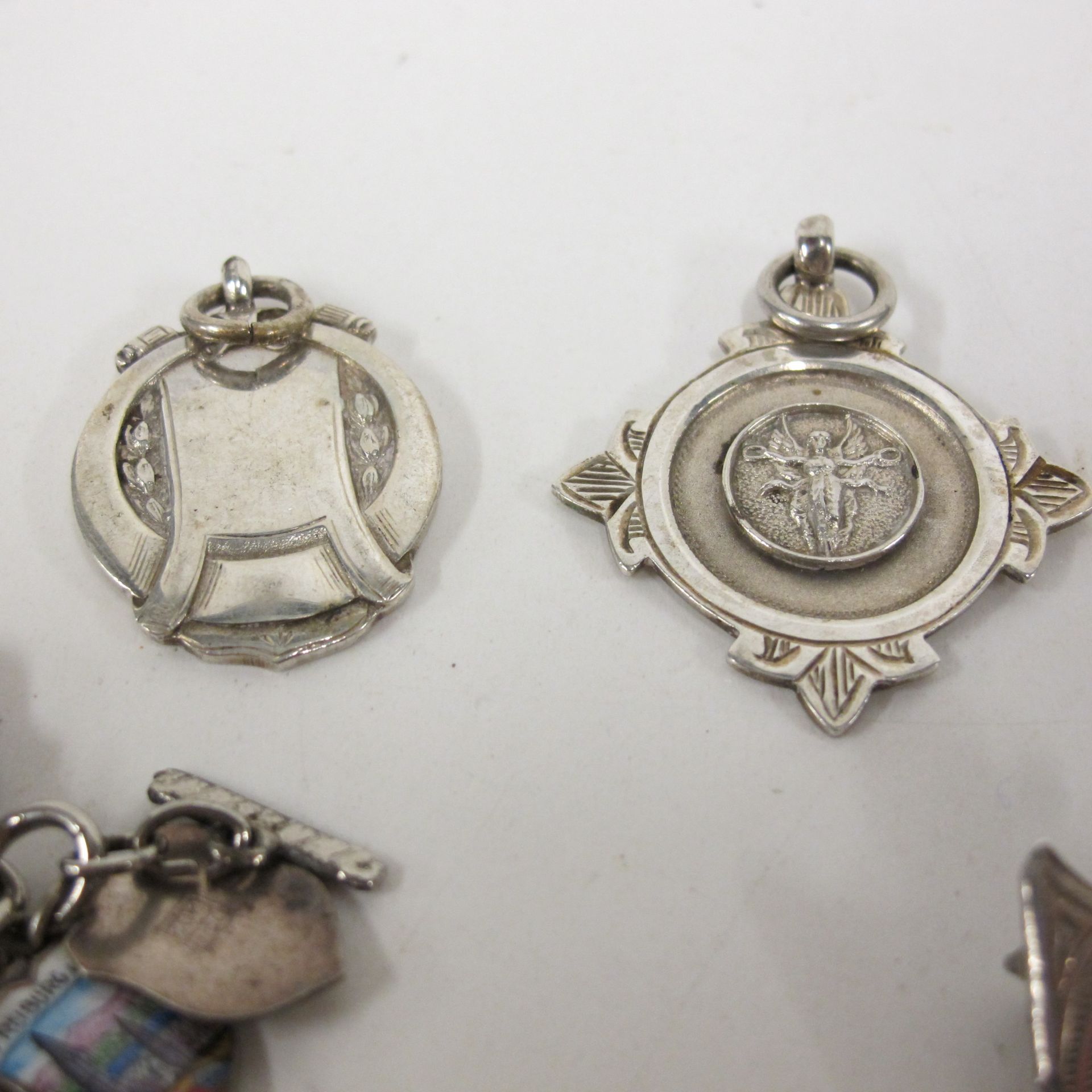 Silver - five fobs, a stag's head brooch, a small chain bracelet, a pencil case and a charm - Image 3 of 4