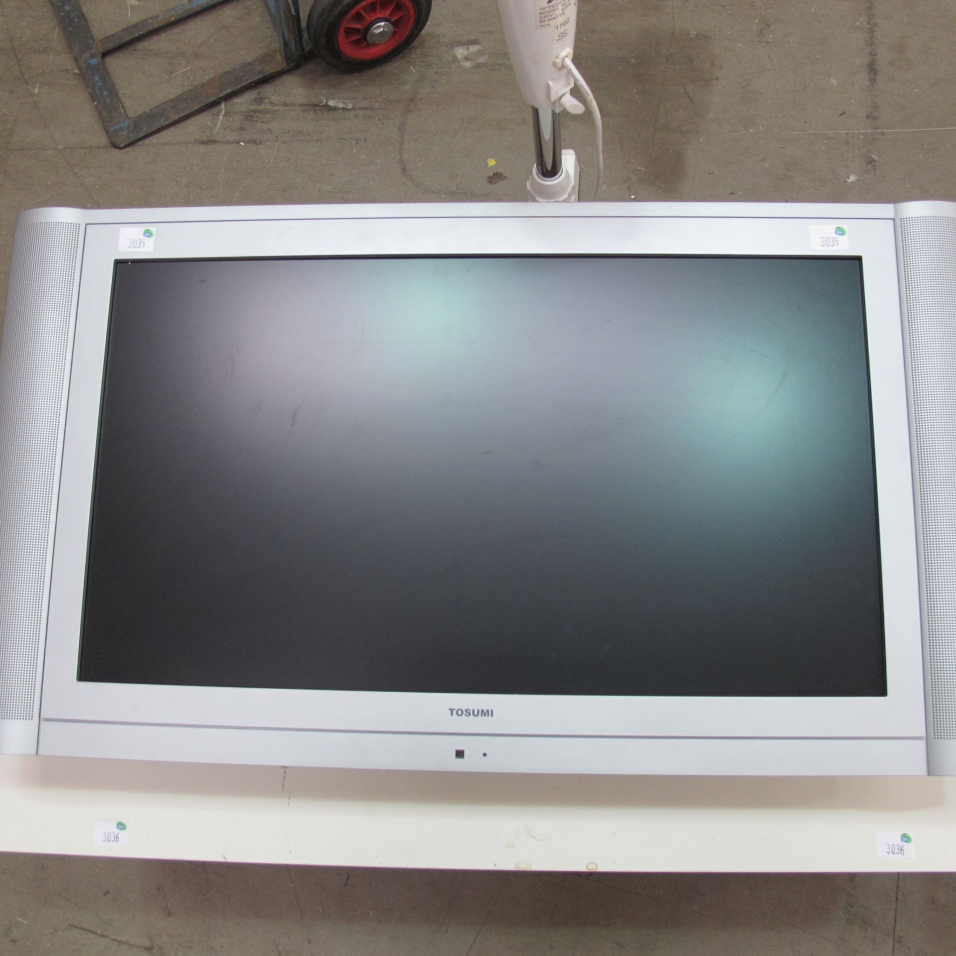 * A Tosumi 26½'' screen TV. Comes with fitted wall mounts and features one HDM1 socket (model number