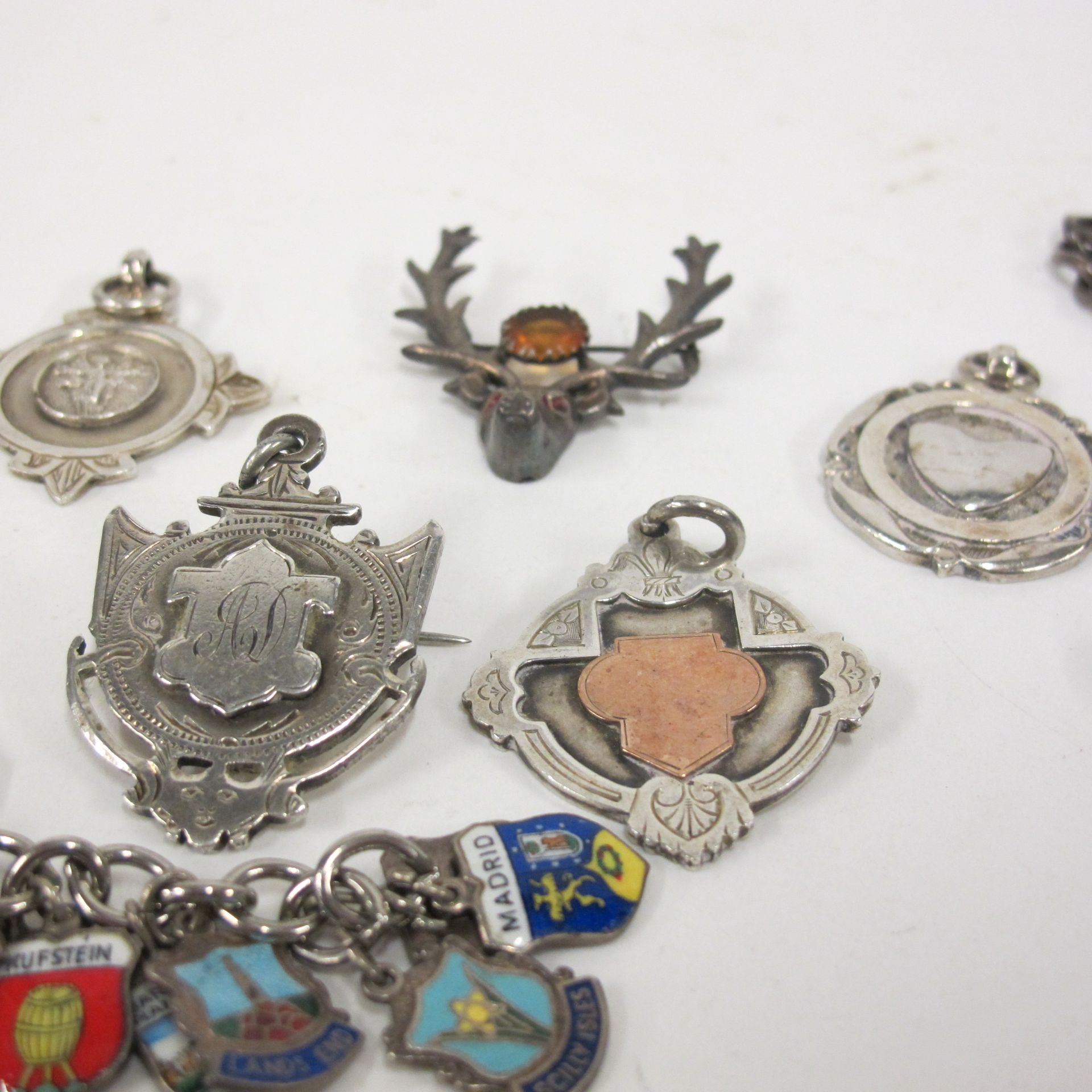 Silver - five fobs, a stag's head brooch, a small chain bracelet, a pencil case and a charm - Image 2 of 4