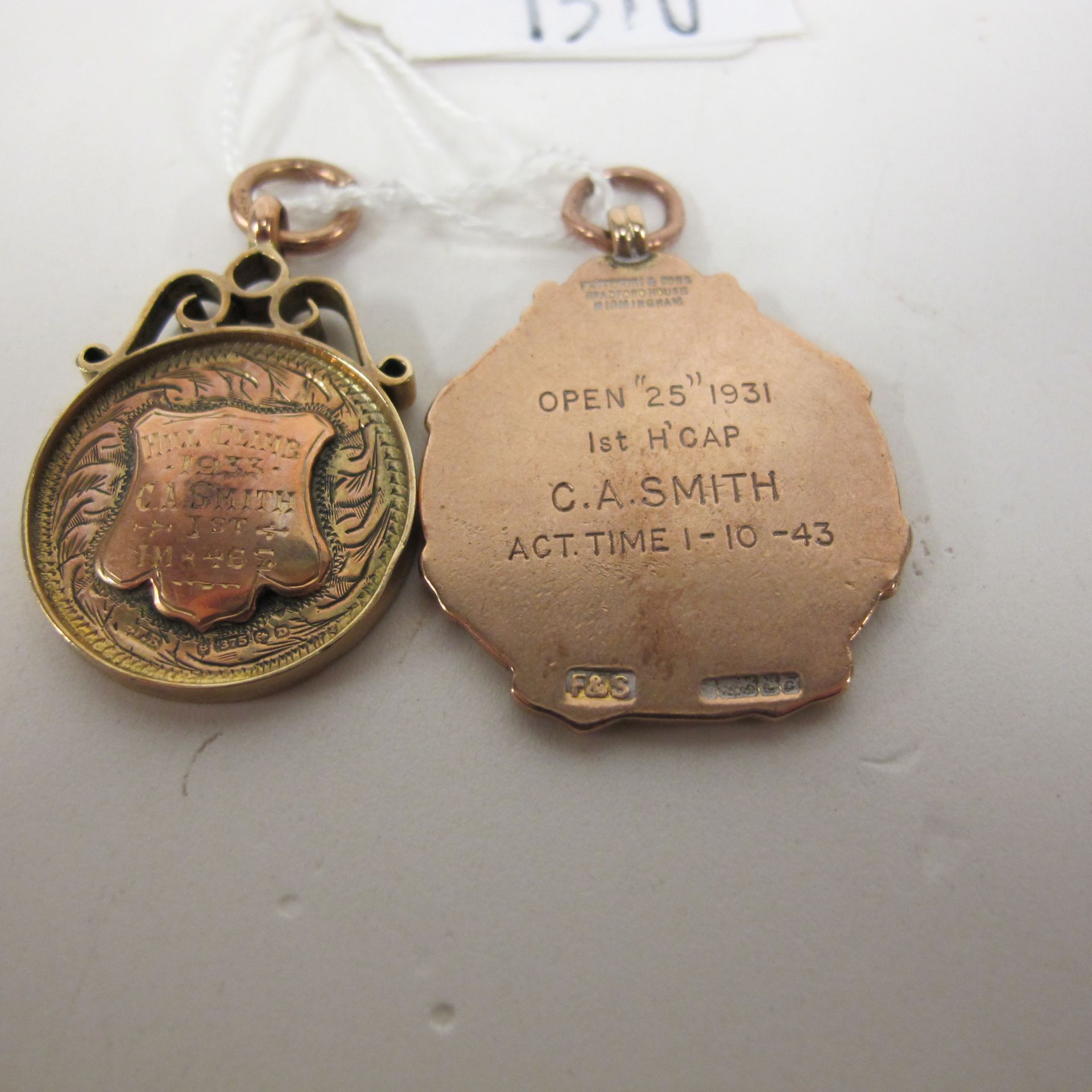 Two 9ct gold fobs (both inscribed), 20gms (est £50-£70)