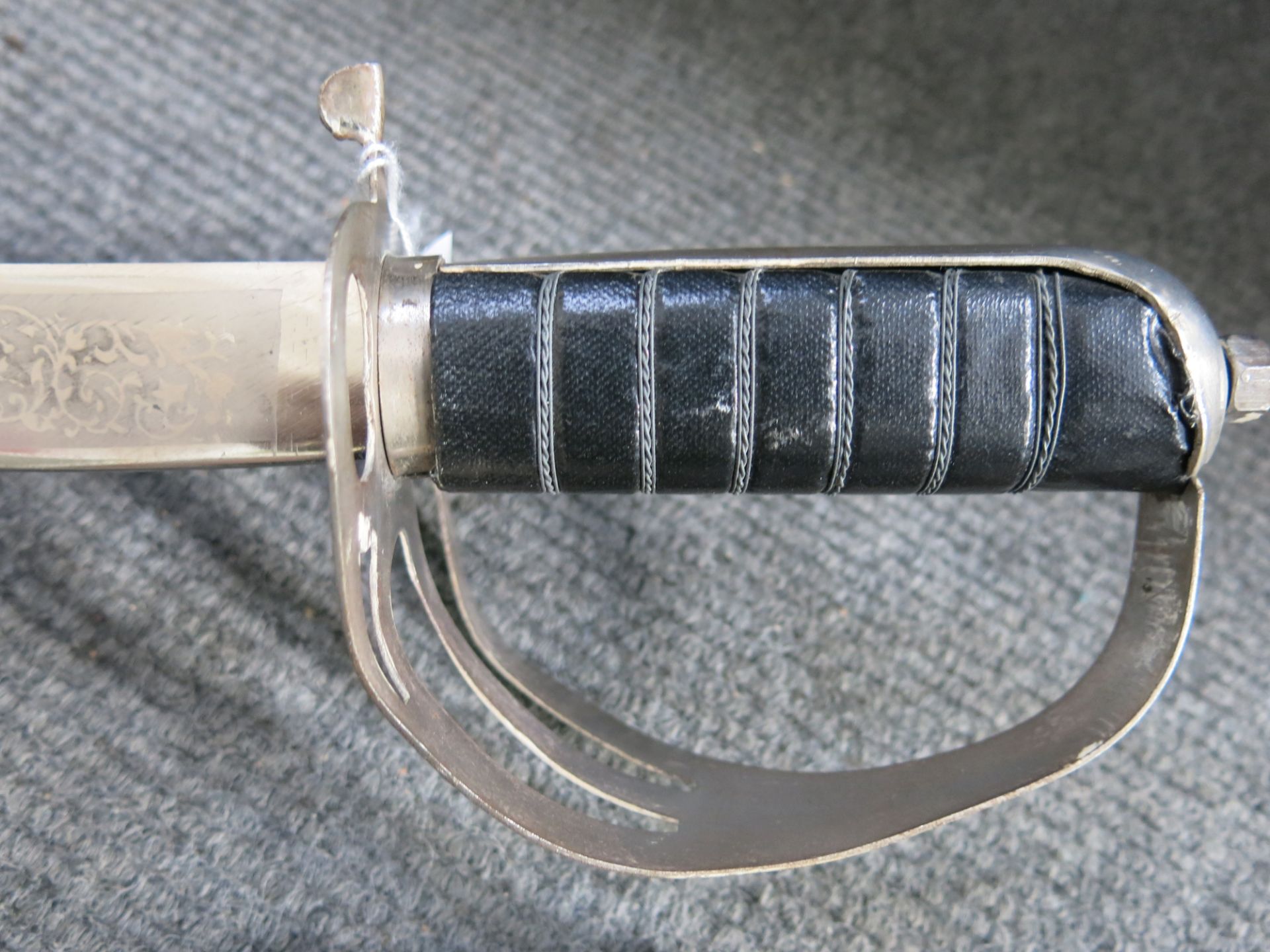 A military style sword engraved/etched finish to both sides of blade along full length. Blade length