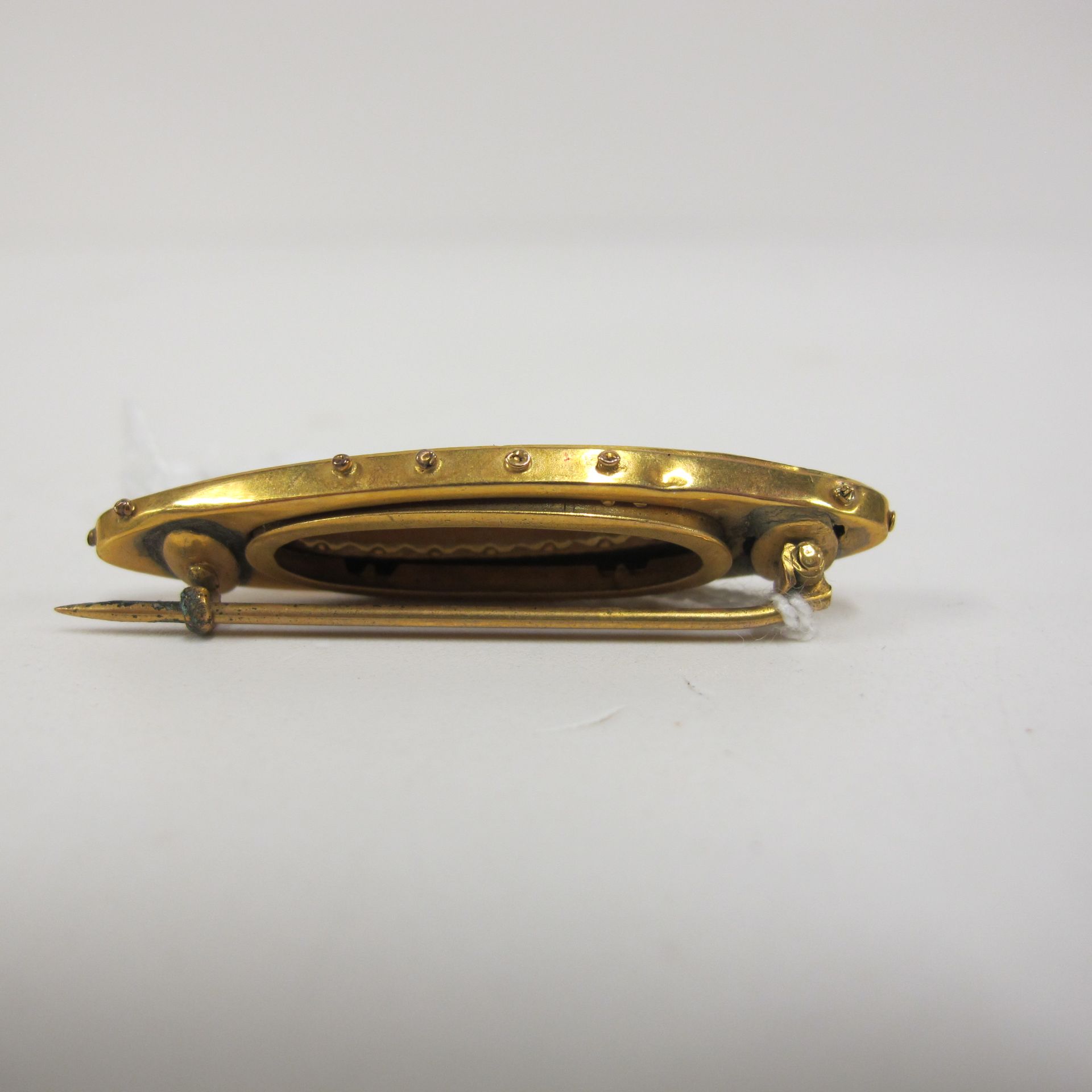 An oval gold brooch set with incomplete set of precious stones, together with another double bar - Image 2 of 2