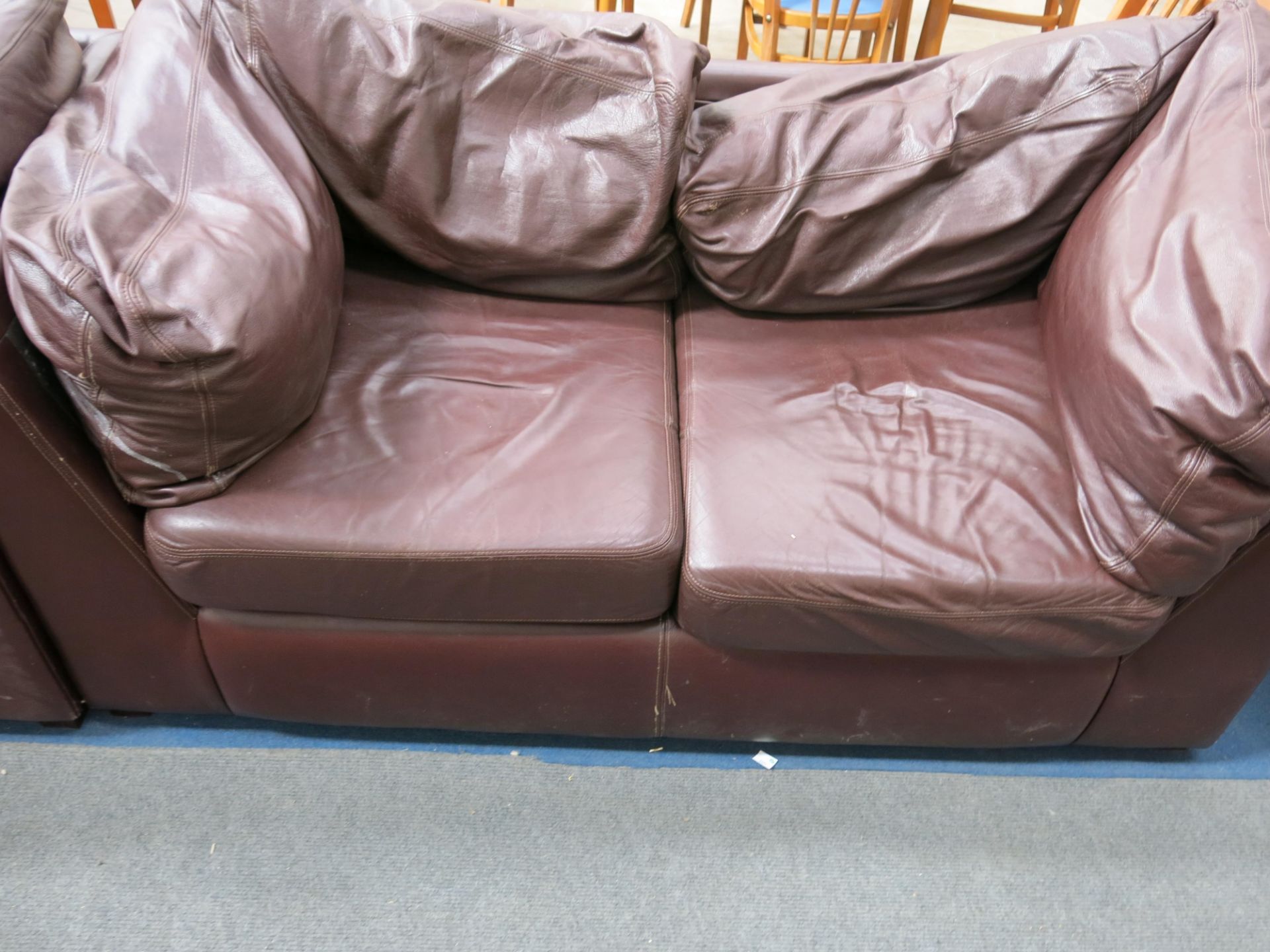 * Two brown leather two seater sofas, ex Costa Coffee (2) (est £100-£120)