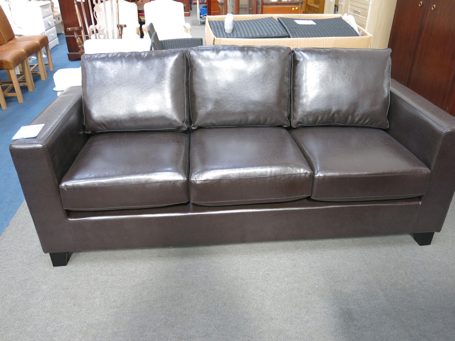 * An as new three seater sofa. The faux pu leather upholstery is brown in colour. Please note - Image 3 of 4
