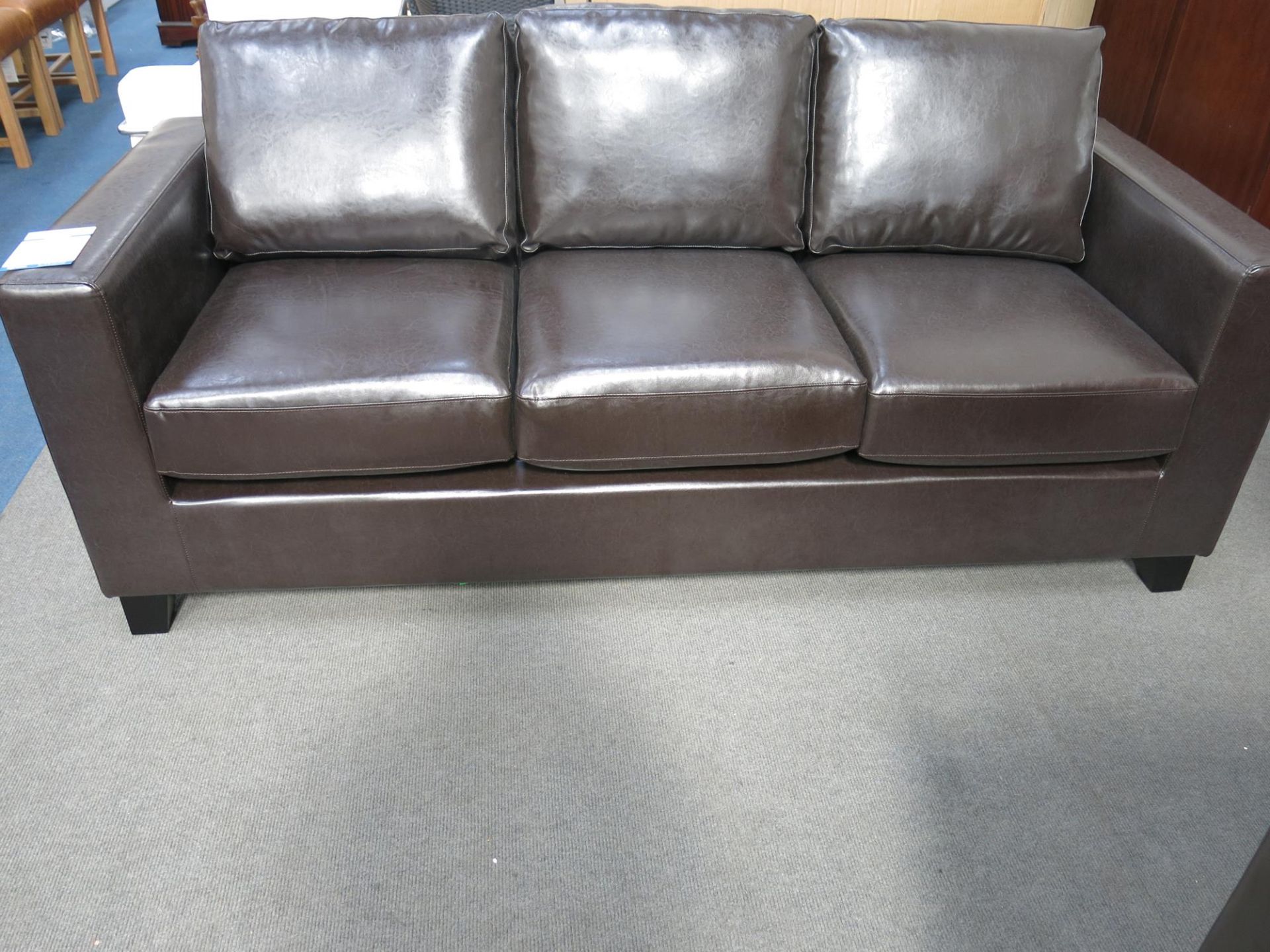 * An as new three seater sofa. The faux pu leather upholstery is brown in colour. Please note - Image 4 of 4