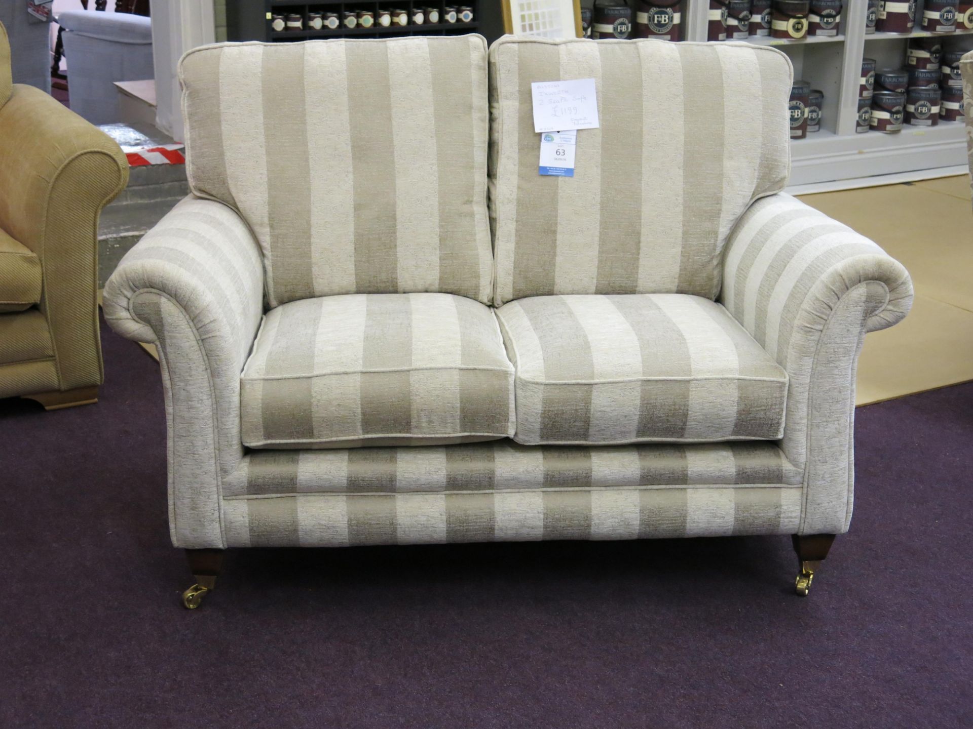 Alstons Ixworth two seat sofa with oyster stripe cover with polished brass castors on front feet.