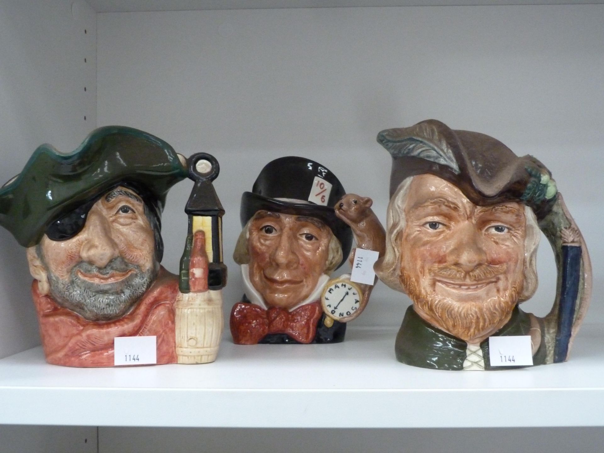 Three Royal Doulton Toby Jugs including 'Robin Hood' D6527, 'Smuggler' D6616 and 'Mad Hatter'