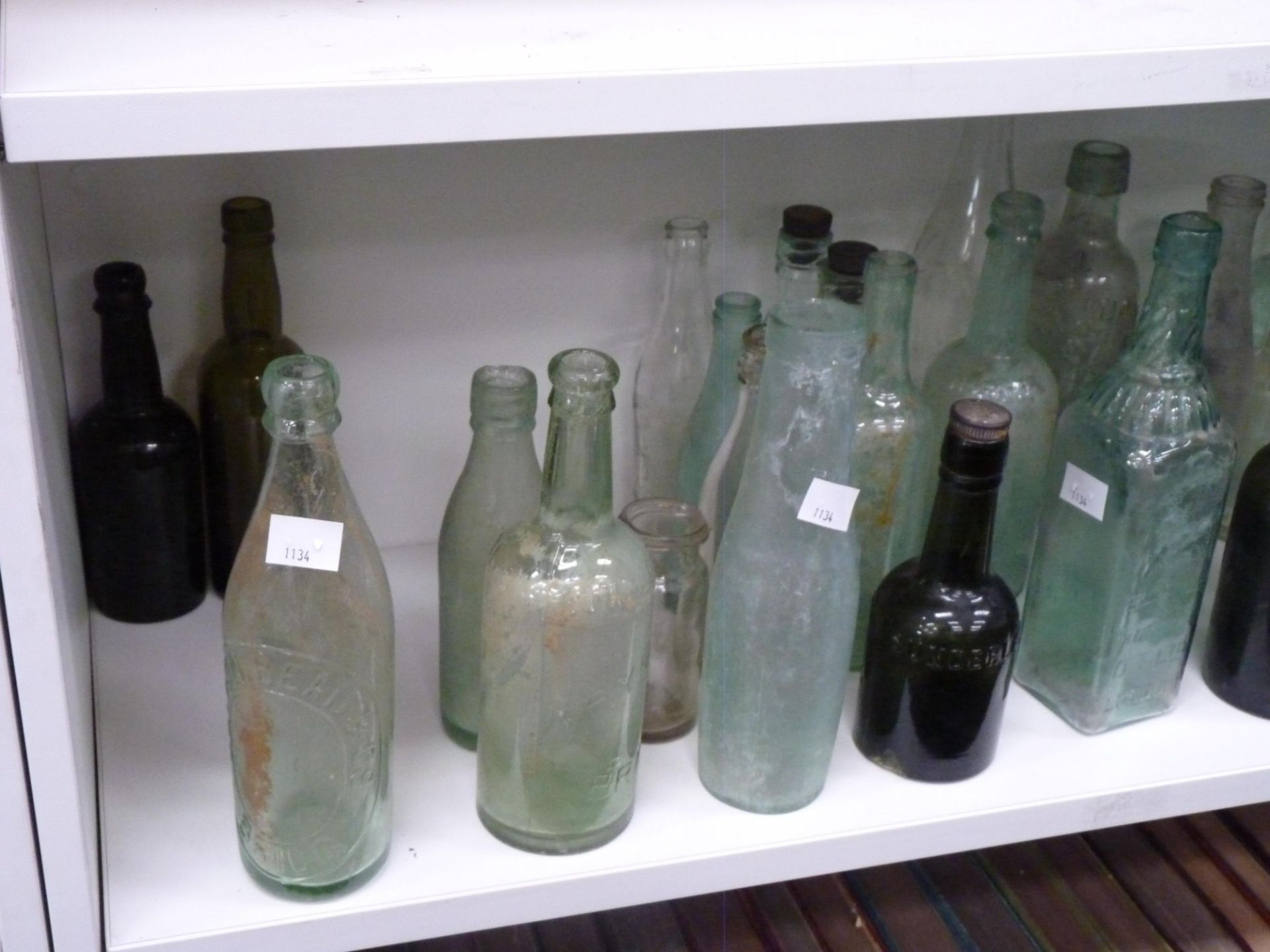 A selection of early clear & green glass bottles with examples of Collingwood - Barton On Humber