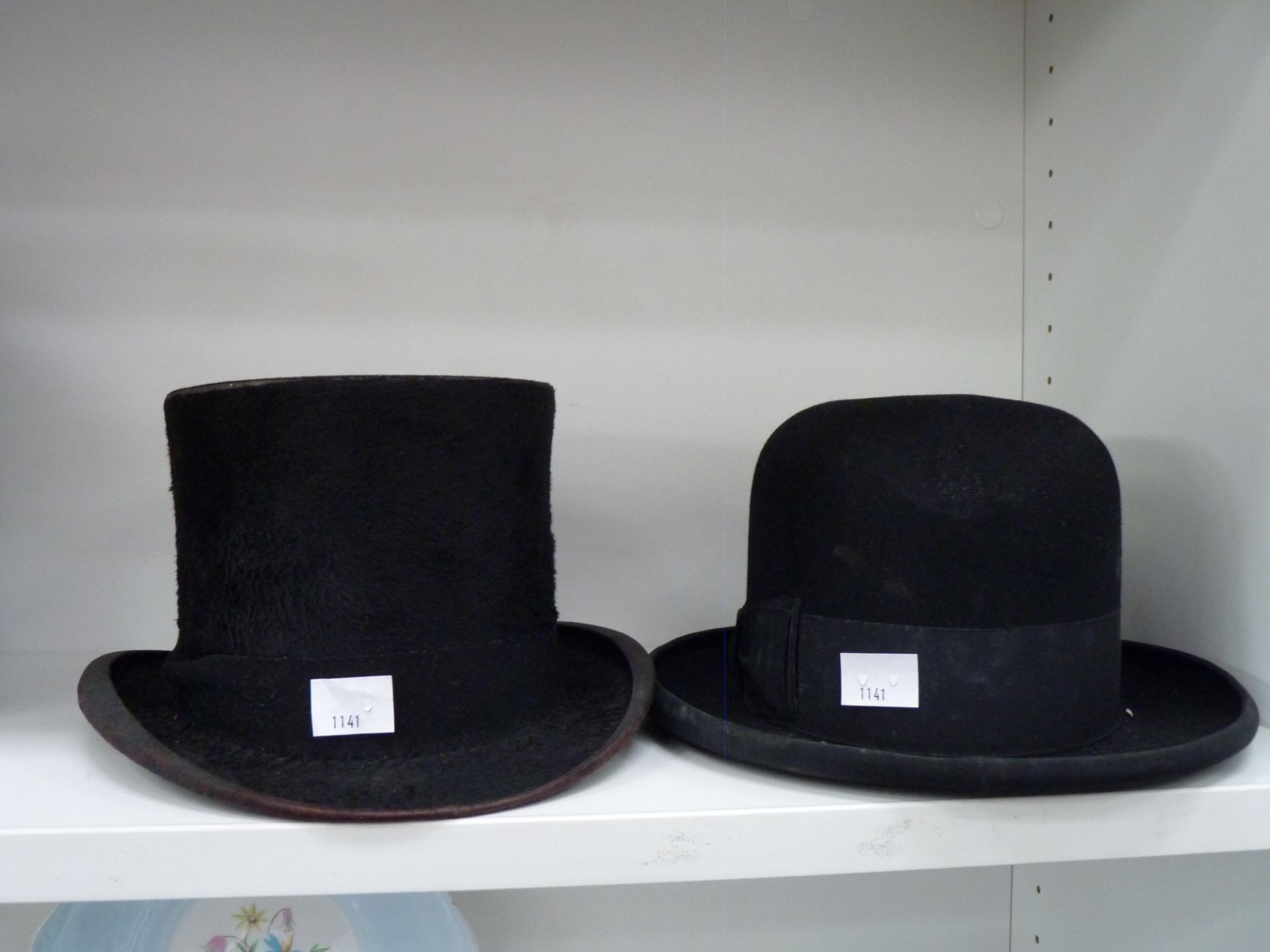 A black 'Battersby & Co' top hat together with a black 'Dunne & Co' bowler hat (est £50-£70)