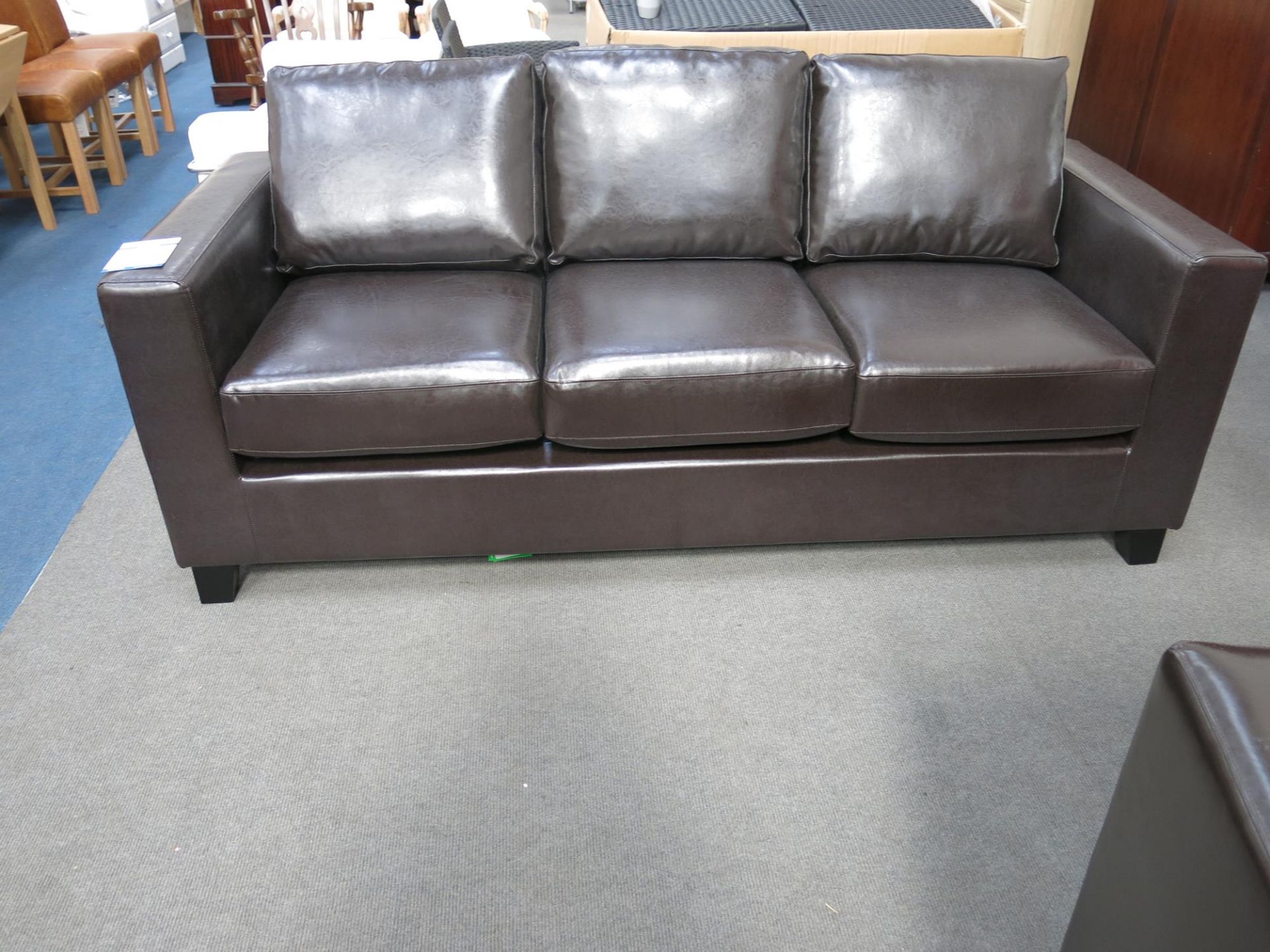 * An as new three seater sofa. The faux pu leather upholstery is brown in colour. Please note - Image 2 of 4