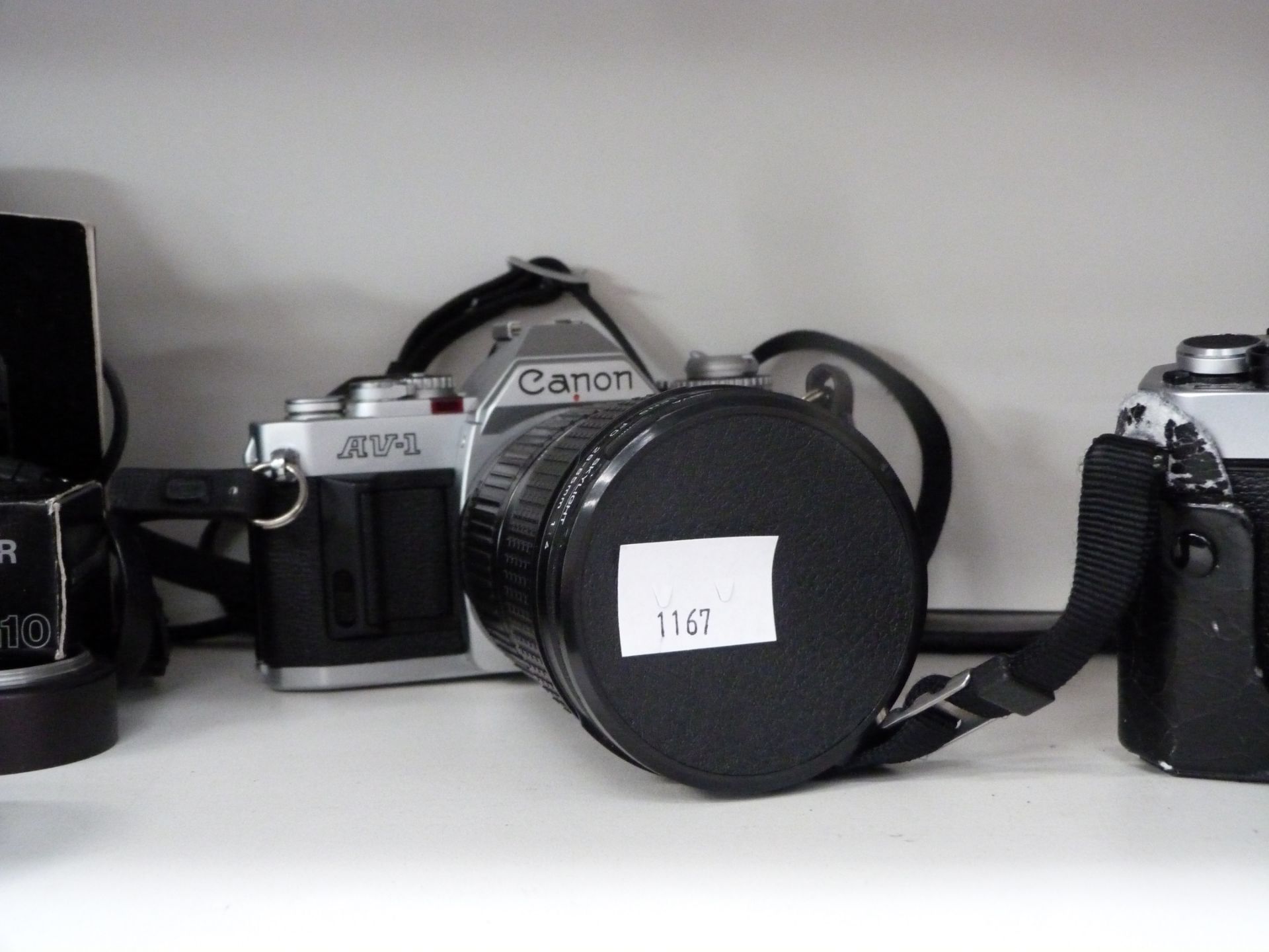 A Canon AV1 35mm camera, Nikon FT 35mm camera and a Nikon TW Zoom 35-70 (est £90-£120)