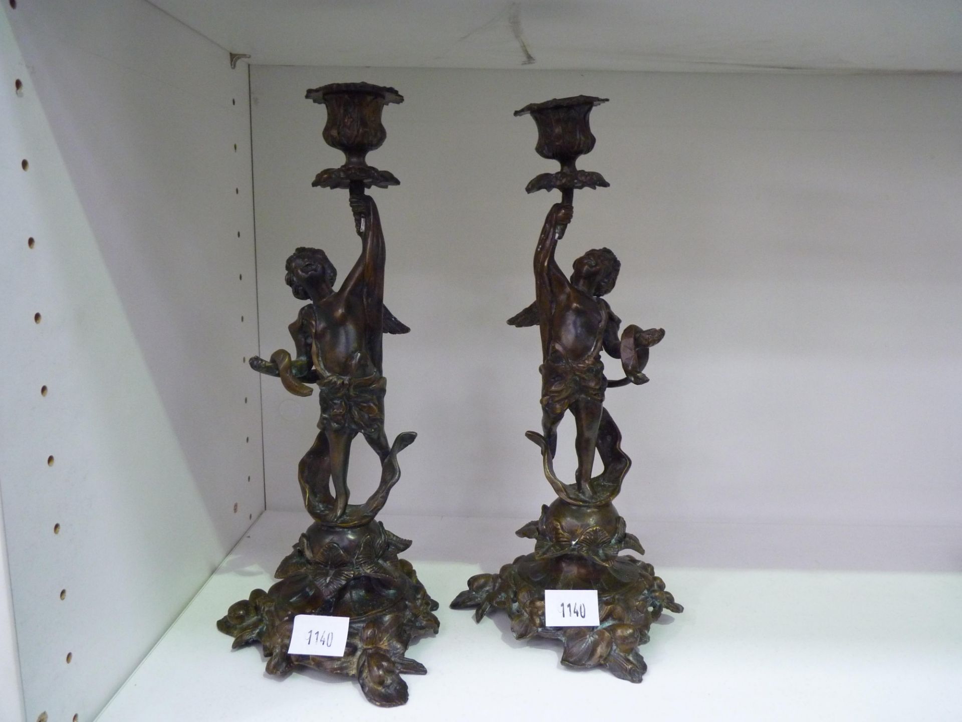 A pair of bronze (?) cherub candle sticks, impressed mark F Souchal, Paris (31cm) (est £30-£50)