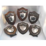 A group of six silver shield shaped trophies mounted on oak shield shaped plaques, Staffordshire