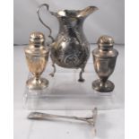 A George III silver cream jug, London 1763, 11cm high, a pair of silver pepperettes London 1822, 8cm