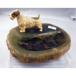 A green onyx ashtray mounted with a cold painted terrier 15cm wide