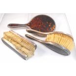 A five piece silver and tortoiseshell dressing table mirror brush set London 1945