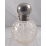 A silver topped cut glass scent bottle of globular form, 13.5cm high