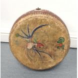 A Chinese circular wooden and leather drum decorated stylised birds 40cm diameter