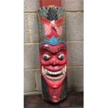A Carved and painted wall mask 67cm high