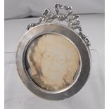 A Victorian circular silver strut photo frame with ribbon bow decoration 7cm diameter