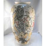 A Moorcroft pottery vase, decorated flowers on a pale yellow ground 31cm high