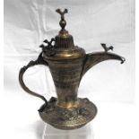 An Arab Islamic brass dallah coffee pot with pierced cover 23cm high