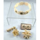 An early20thC black forest carved flower bracelet and similar brooches