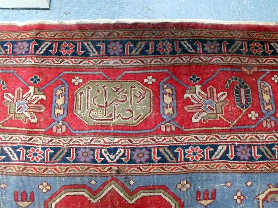 A large Persian floor carpet decorated stylised flowers on a red ground 354cm x 453cm (wear) - Image 3 of 9
