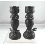 A pair of Victorian carved Irish bog oak candlesticks, in the form of owls, the sconces carved