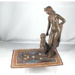 A cold painted woman and a panther standing on an Eastern rug 16cm high