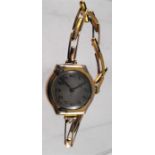 A 9ct gold ladies watch with expanding strap
