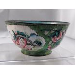 An 18thC Chinese enamel bowl decorated figures and flowers on a green ground 10.5cm diameter